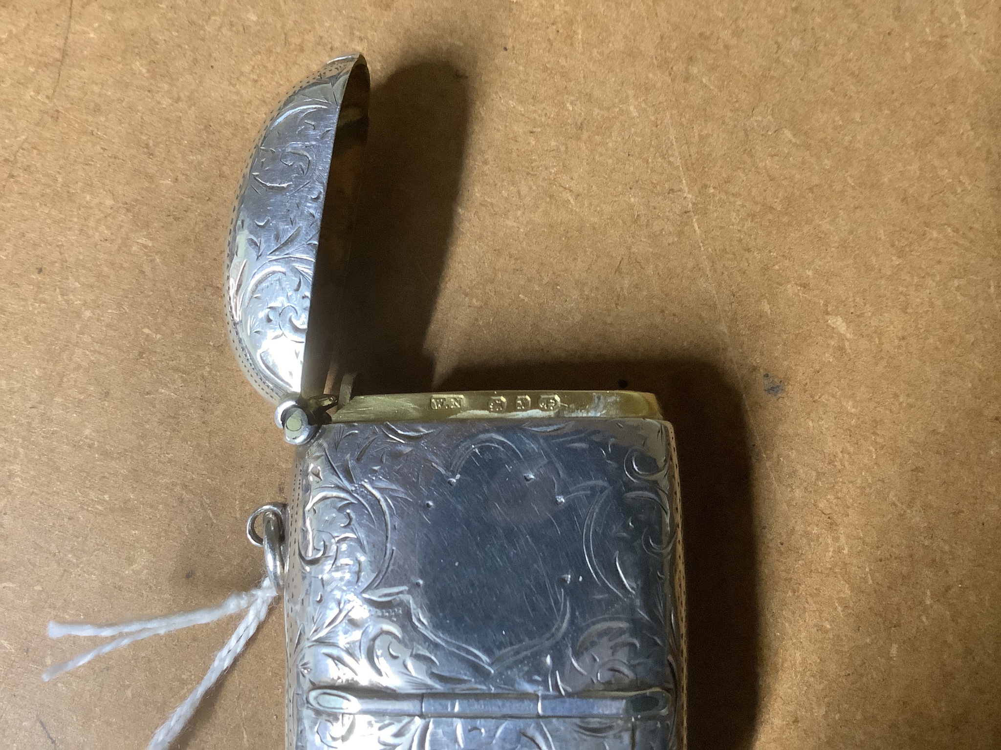 A late Victorian engraved silver combination sovereign, vesta and stamp case, the interior with removable toothpick and pencil, William Neale Ltd, Birmingham, 1897, 63mm.
